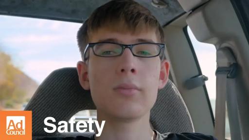 Teen with glasses in a car.