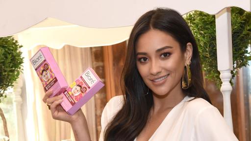Shay Mitchell holding up Biore strips.