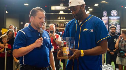 Brent Chism from Snapple Brand Marketing presents Cliff Floyd with the “Flip for Flavor” trophy after winning the first-ever Snapple All-Star Bottle Flip Challenge at MLB FanFest. Cliff Floyd won after accurately flipping bottles onto fruit bases resembling a baseball diamond on Tuesday, July 17 in Washington.