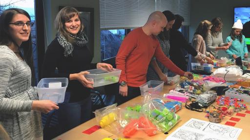 Volunteers assemble care packages for kids.