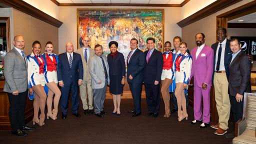 Standing in a large room a gathering of people  L-R: New York Rangers legend Adam Graves; Radio City Rockettes Sam Berger and Tiffany Billings; NHL Deputy Commissioner Bill Daly; NBA Commissioner Adam Silver; The Madison Square Garden Company Executive Chairman and CEO Jim Dolan; PepsiCo Chairman and CEO Indra Nooyi; The Madison Square Garden Company President Andy Lustgarten; PepsiCo North America CEO Al Carey; Radio City Rockettes Danelle Morgan and Taylor Shimko; New York Rangers legend Ron Duguay; New York Knicks legend Walt Frazier; New York Knicks legend Larry Johnson; New York Rangers legend Mike Richter.