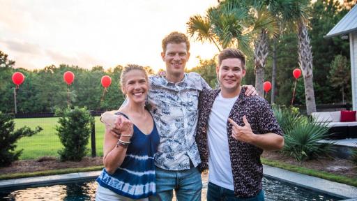 Three people smiling for the camera outside in front of a pool.