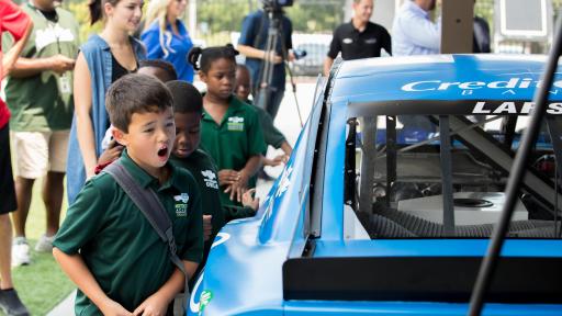 Credit One Bank and Kyle Larson visit with Meeting Street Academy students