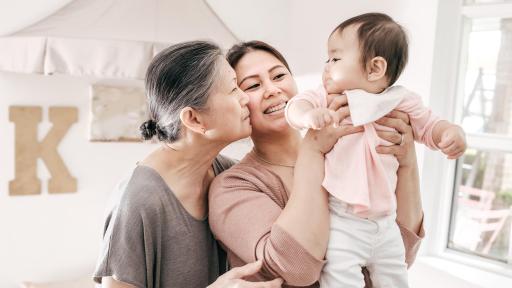 Two women looking at a baby
