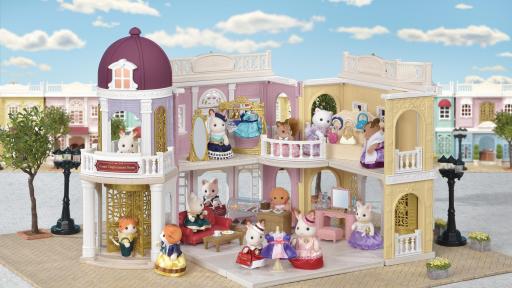 The toys Calico Critters in various rooms in a toy mall-like setting.