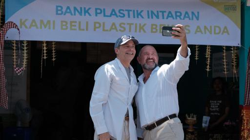 Fisk Johnson, Chairman and CEO of SC Johnson and David Katz, CEO of Plastic Bank, taking selfies in front of a sign.
