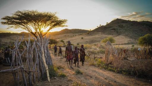 Tribesmen in the Omo Valley of Ethiopia in the golden glow of sunset. © G Adventures, Inc.