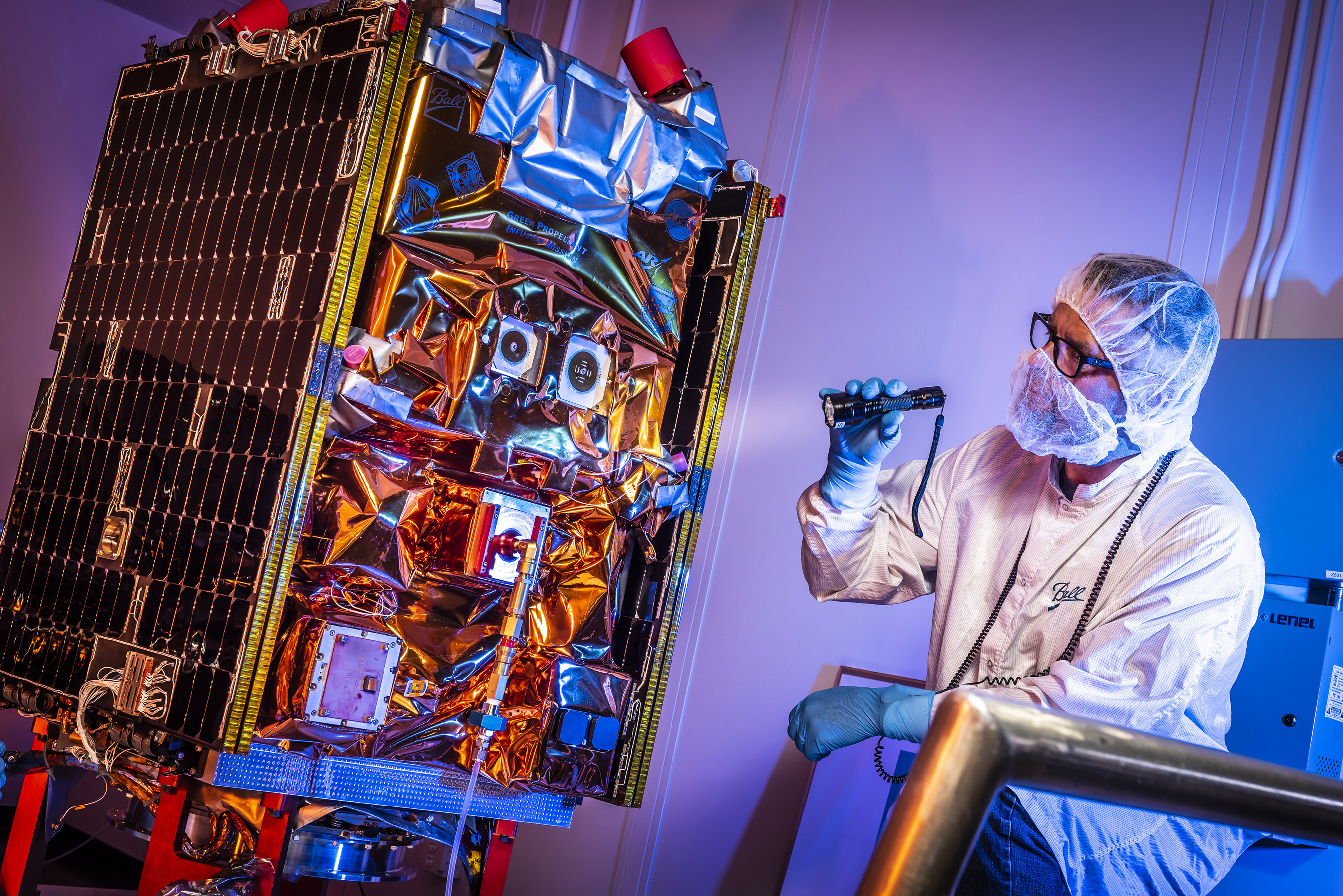 Aerospace engineer performs final checks before the GPIM satellite is shipped to Florida for launch