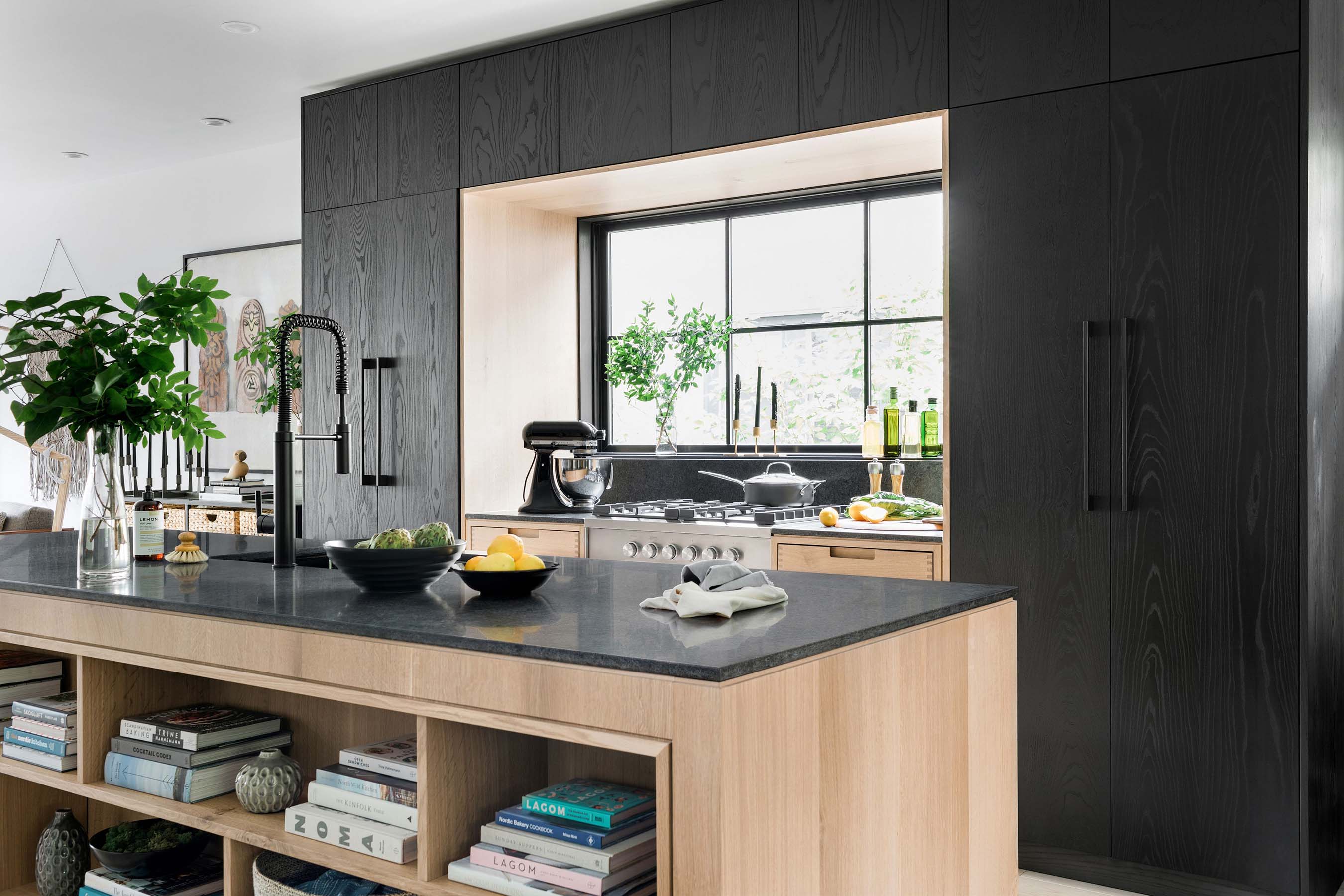 A perfect example of “less is more,” the kitchen of the HGTV Urban Oasis 2019 is modern and open, featuring floor-to-ceiling cabinetry with integrated storage, a concealed refrigerator, and a massive island with two dishwasher drawers.