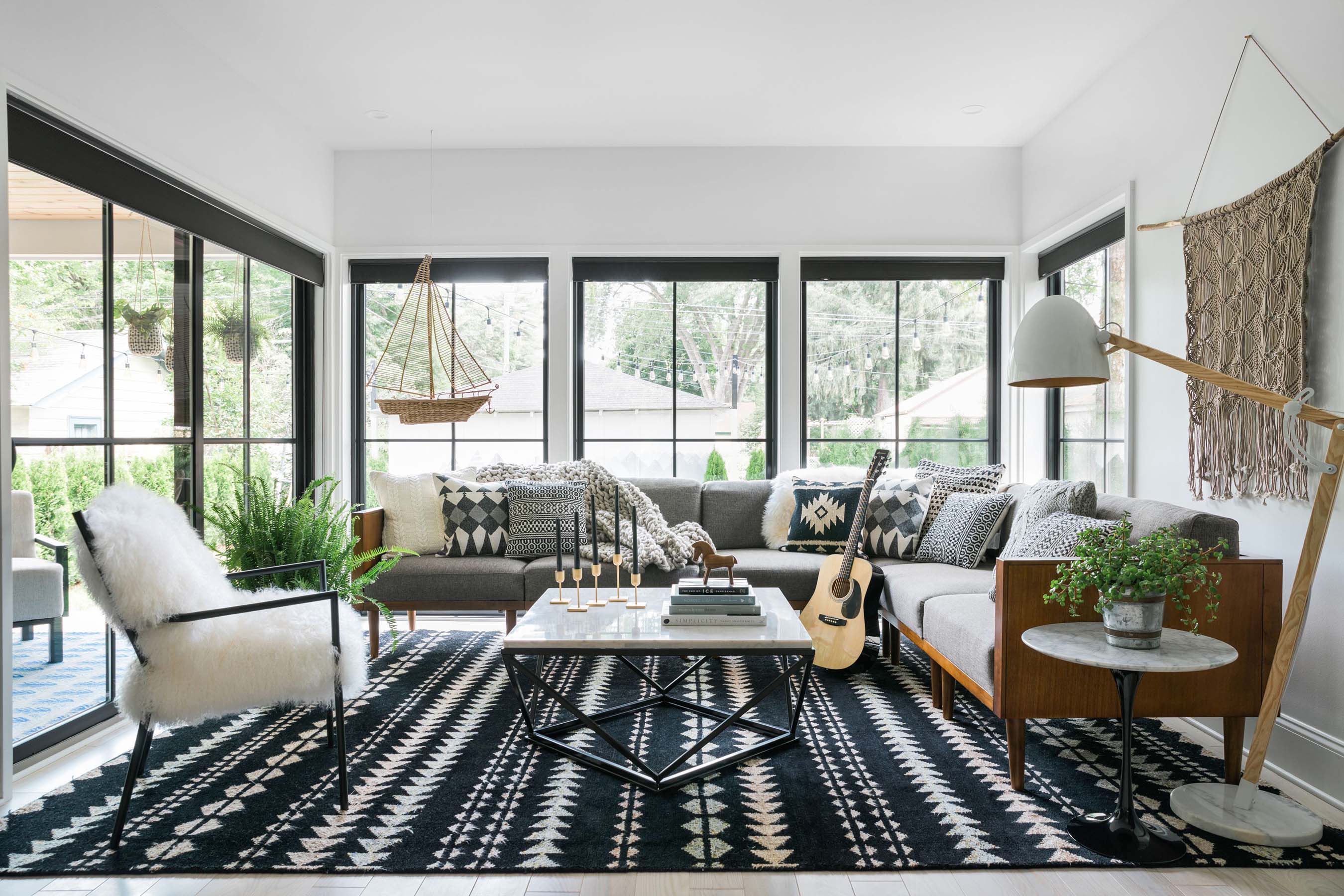 The picture of comfy-cozy, the HGTV Urban Oasis 2019 living room boasts a 10-person sectional and lots of contrasting black-and-white décor, not to mention an oversized wall mural reflecting a classic Nordic sweater pattern.