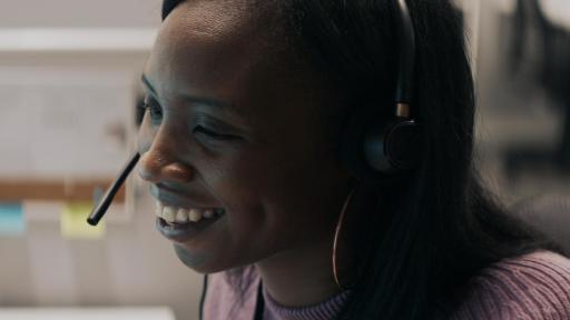 Woman wearing headset and smiling