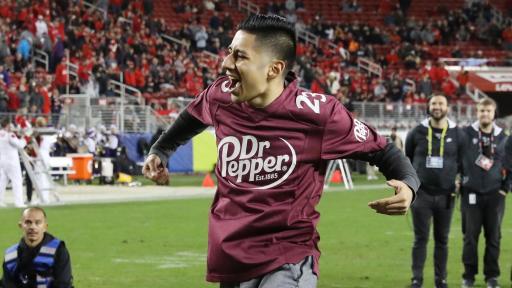 Alberto Reyes celebrates after winning $100,000 in tuition after competing in the Dr Pepper Tuition Giveaway during halftime of the PAC-12 Conference Championship