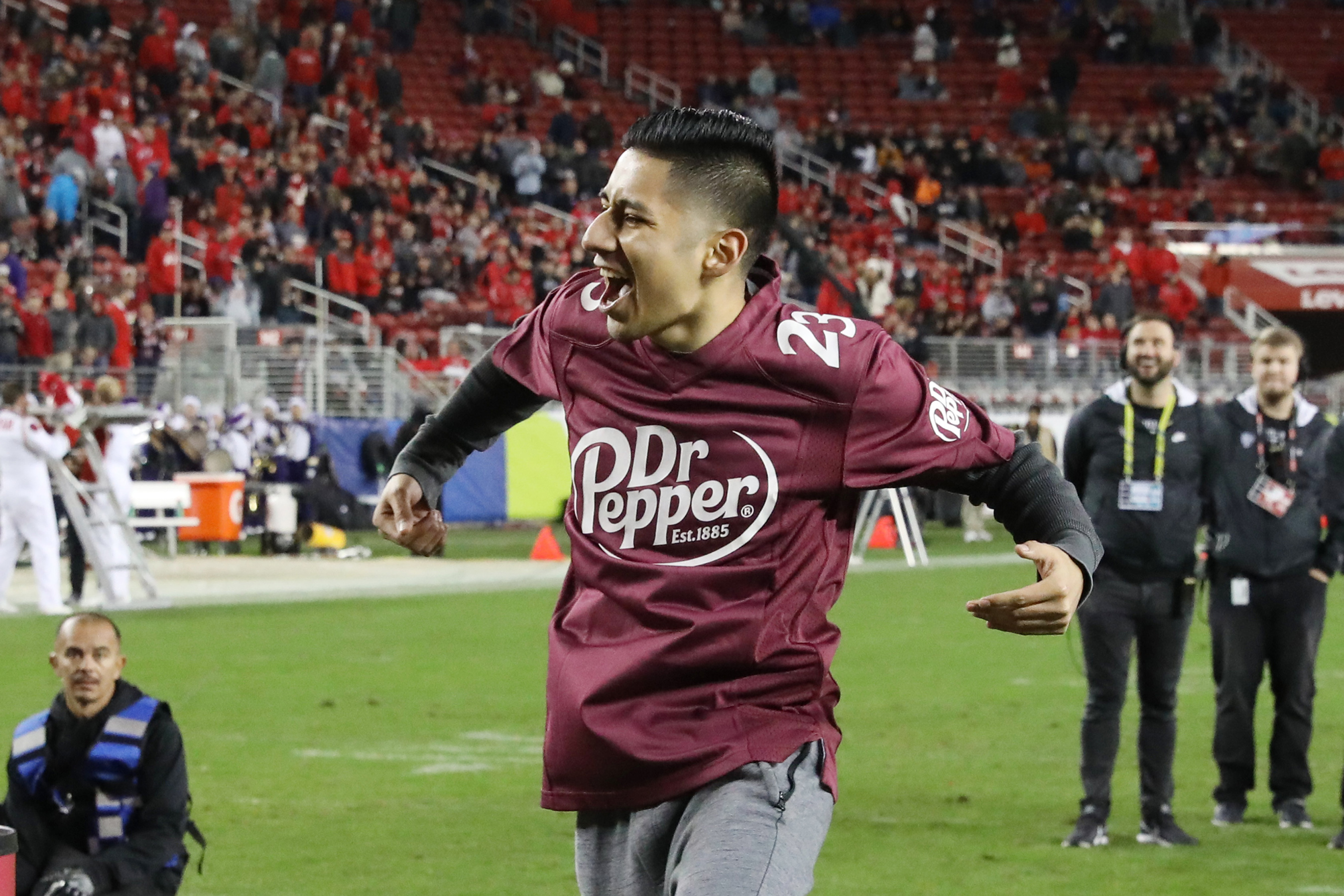 Alberto Reyes celebrates after winning $100,000 in tuition after competing in the Dr Pepper Tuition Giveaway during halftime of the PAC-12 Conference Championship