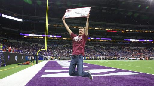 Caleb Lines was presented with a check for $100,000 in tuition after winning the Dr Pepper Tuition Giveaway during halftime of the Big Ten Conference Championship