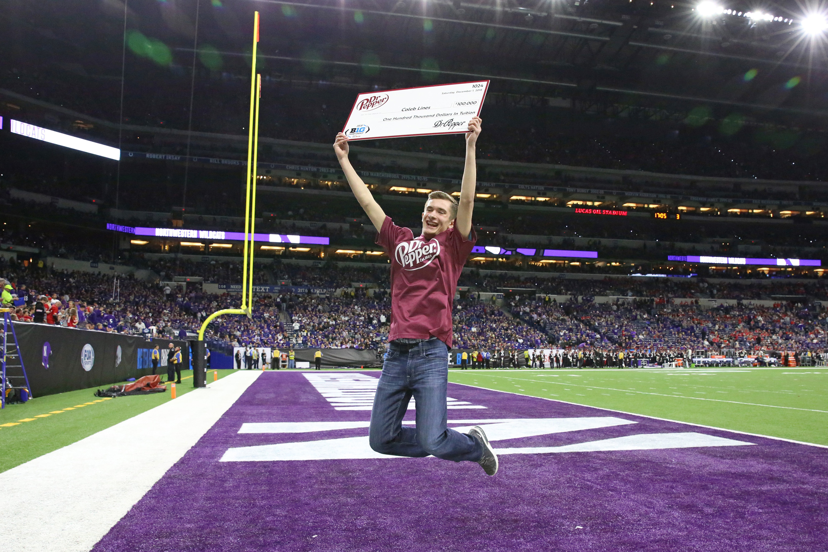 Caleb Lines was presented with a check for $100,000 in tuition after winning the Dr Pepper Tuition Giveaway during halftime of the Big Ten Conference Championship