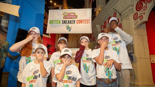 Kids plugging their nose at the Rotten Sneaker event.