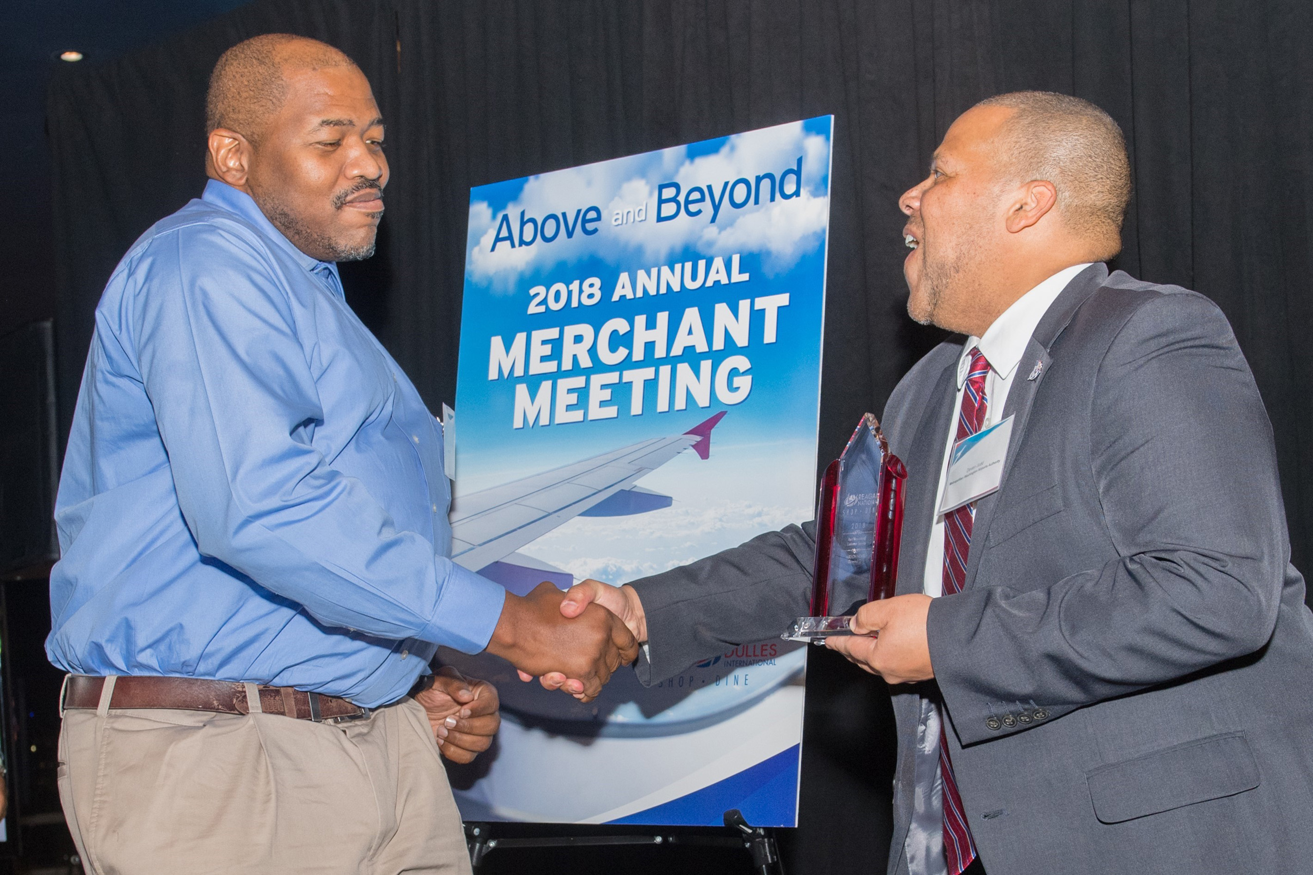 Reagan National Airport Best Newsstand Customer Service winner Hudson News’ General Manager Tony Tucker accepting award from Deven Judd, Director of Customer & Concessions Development with The Metropolitan Washington Airports Authority