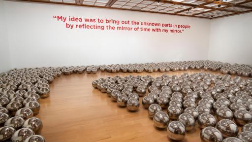 mirrored spheres displayed en masse that create a dynamic reflective field