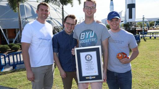Four guys holding Guinness World Record Award