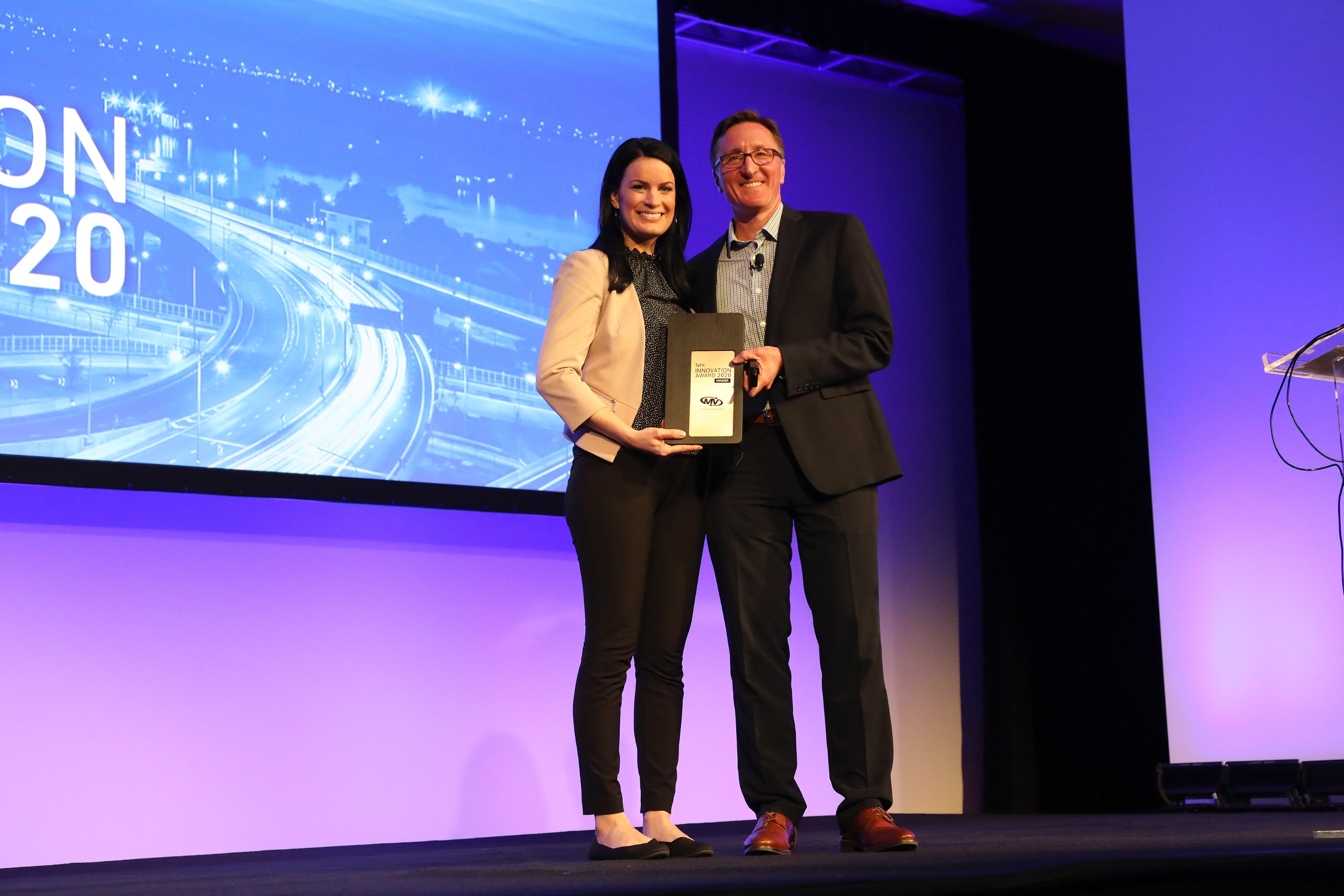 Stephanie Weber, Vice President of Safety Operations, MV Transportation, accepts Lytx inaugural 2020 Lytx Innovation Award from David Riordan, Lytx EVP and Chief Client Officer, at Lytx’s User Group Conference. MV is a co-winner of the award, with Dycom Industries.