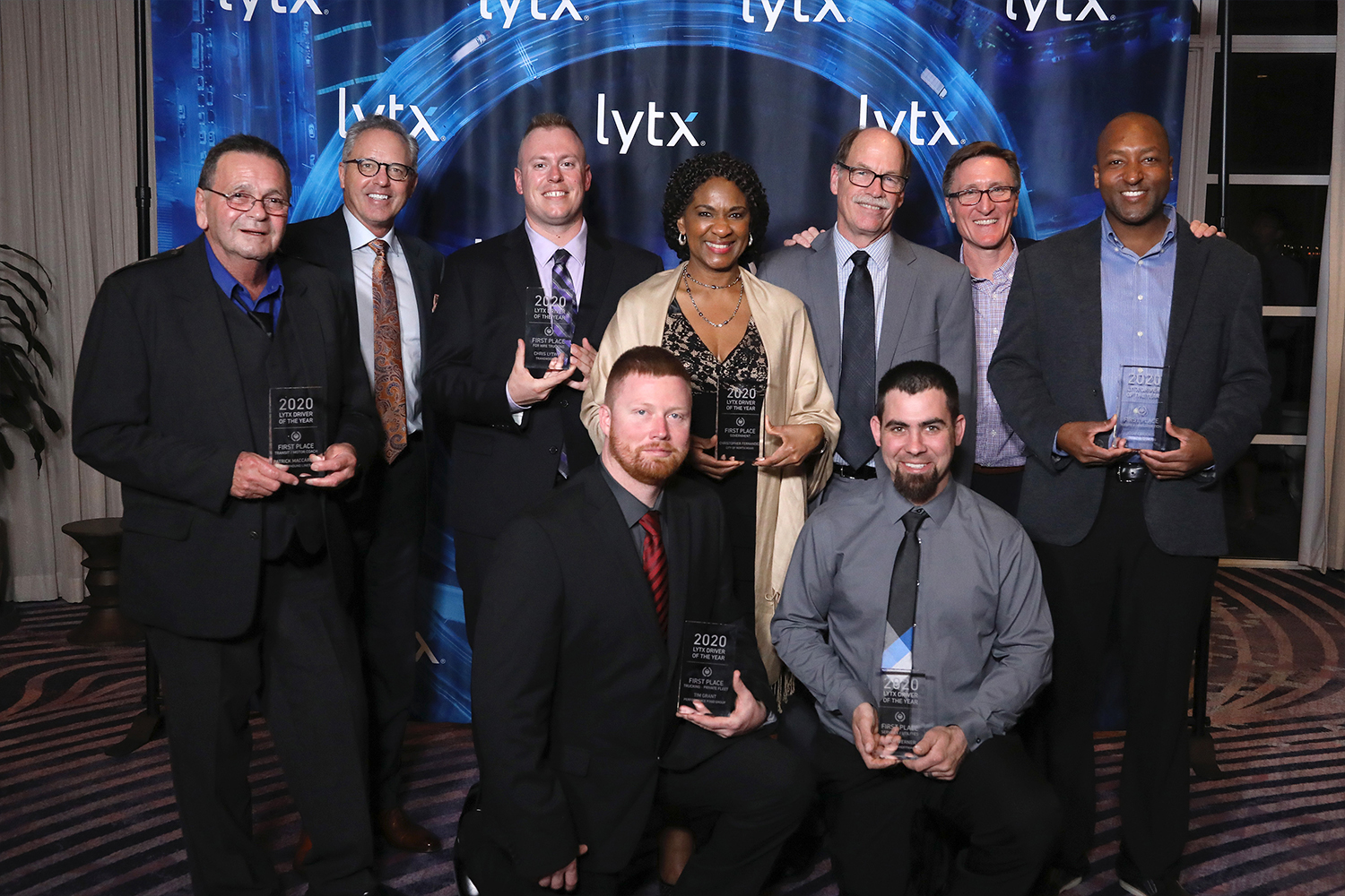 Lytx Driver of the Year Winners, Back Row L – R: Patrick Maccarelli of Greyhound Lines, Driver of the Year, Transit and Motor Coach Category; Brandon Nixon, Lytx CEO; Chris Lytwyn of TransWood Carriers, Driver of the Year, For Hire Trucking Category; Karen Muir of City of North Miami, accepting for Christopher Fernandez, Driver of the Year, Government Category; Del Lisk, Lytx VP of Safety Services; David Riordan, Lytx EVP and Chief Client Officer; Jody Crooks, Waste Connections, Driver of the Year, Waste and Construction Category. Front Row Kneeling L-R: Tim Grant of Performance Food Group, Driver of the Year, Private Trucking Category; Adam Werner of the Murphy-Hoffman Company, Driver of the Year, Services and Utilities Category