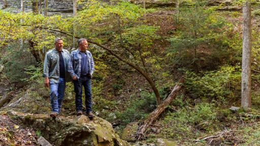 Designer Cottage homeowners, Jack and Harlen, explore the hiking trails of the Deer Lick Falls tiny community.