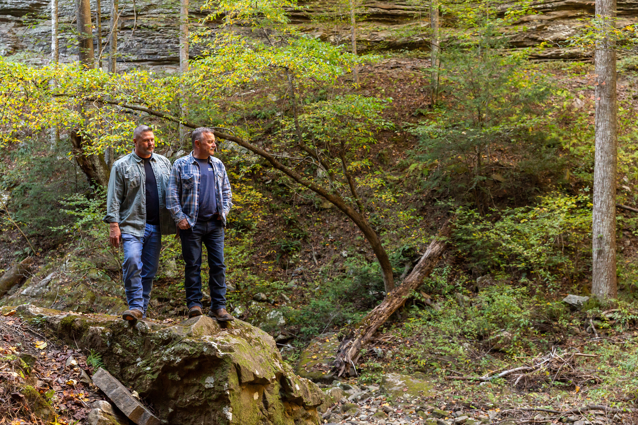 Designer Cottage homeowners, Jack and Harlen, explore the hiking trails of the Deer Lick Falls tiny community.