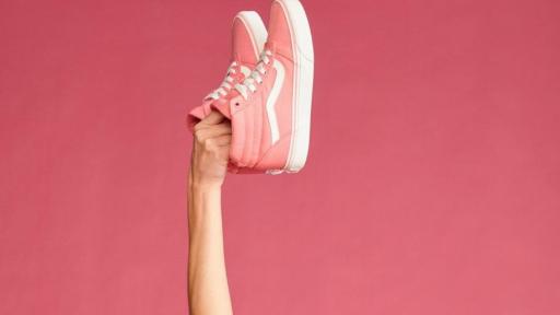 Woman holding up pink shoes
