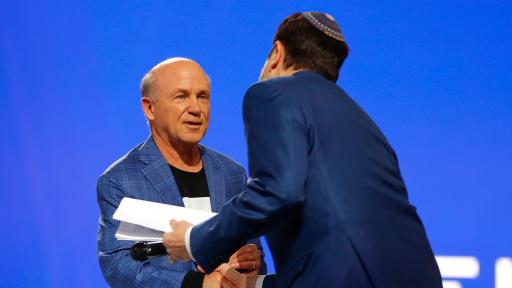 Chick-fil-A CEO Dan Cathy, honorary co-chair of the Beloved Benefit, welcomes Rabbi Peter Berg to the stage for the invocation during the event on Thursday, March 21, 2019 at Mercedes-Benz Stadium in Atlanta.