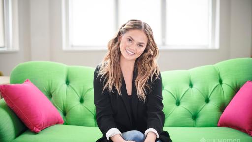 Smiling woman sitting on a green sofa