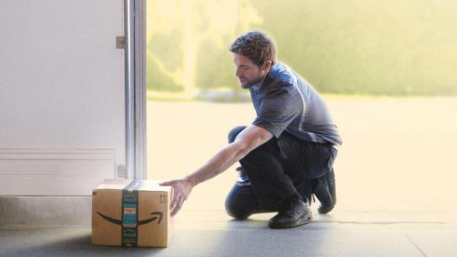 Amazon delivery driver putting a package in a garage.