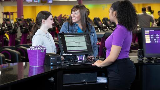 Planet Fitness worker checking people in at a desk