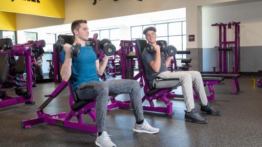 Two teen males lifting weights