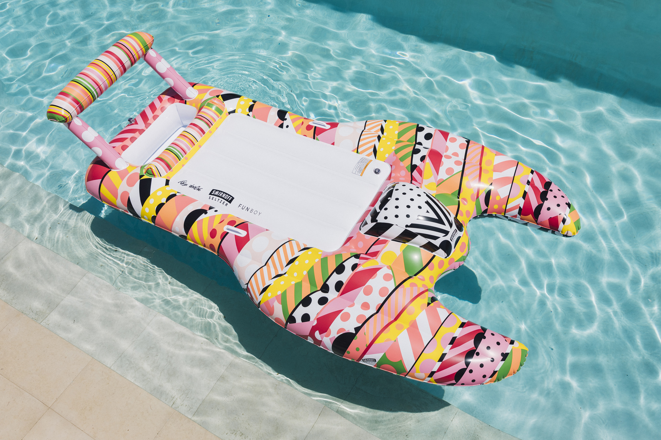 Smirnoff Seltzer and FUNBOY collaborated with acclaimed artist Jason Woodside to design this one-of-a-kind hydroplane pool float, inspired by the delicious Smirnoff Seltzer flavors.