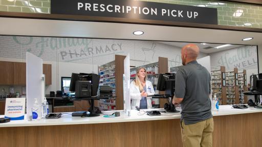 Man speaking to a pharmacist at the counter
