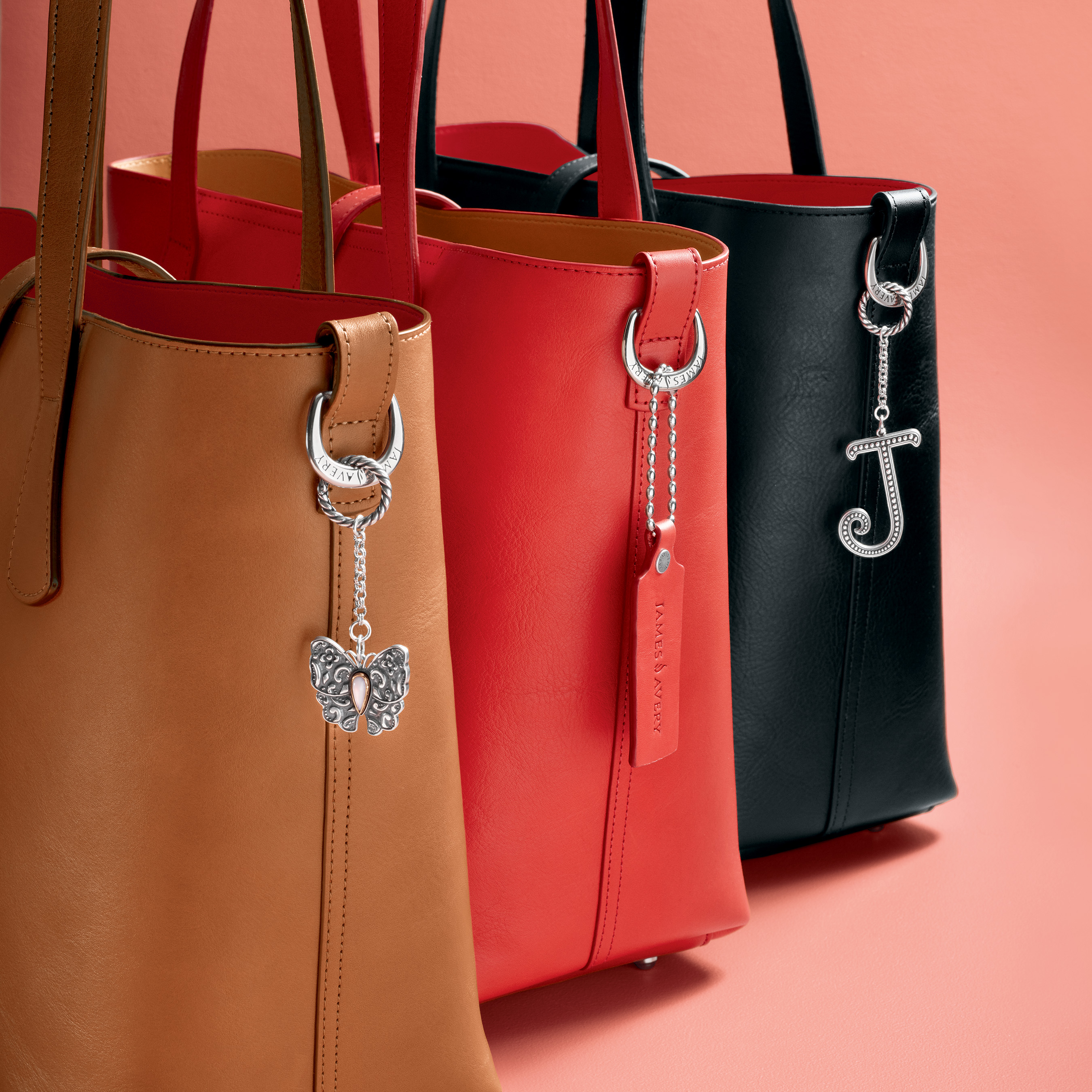Crafted from premium-quality Italian leather treated to make the inside water resistant and more durable. Available in black, chestnut or red leather. Customize any handbag by purchasing a charm holder and select a personal charm.