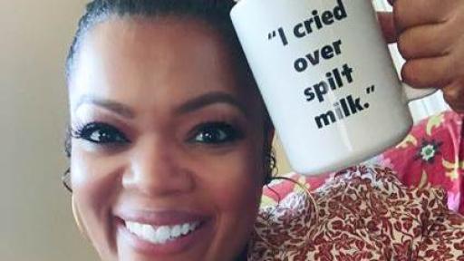 Yvette Nicole Brown holding an I Cried Over Spilt Milk mug
