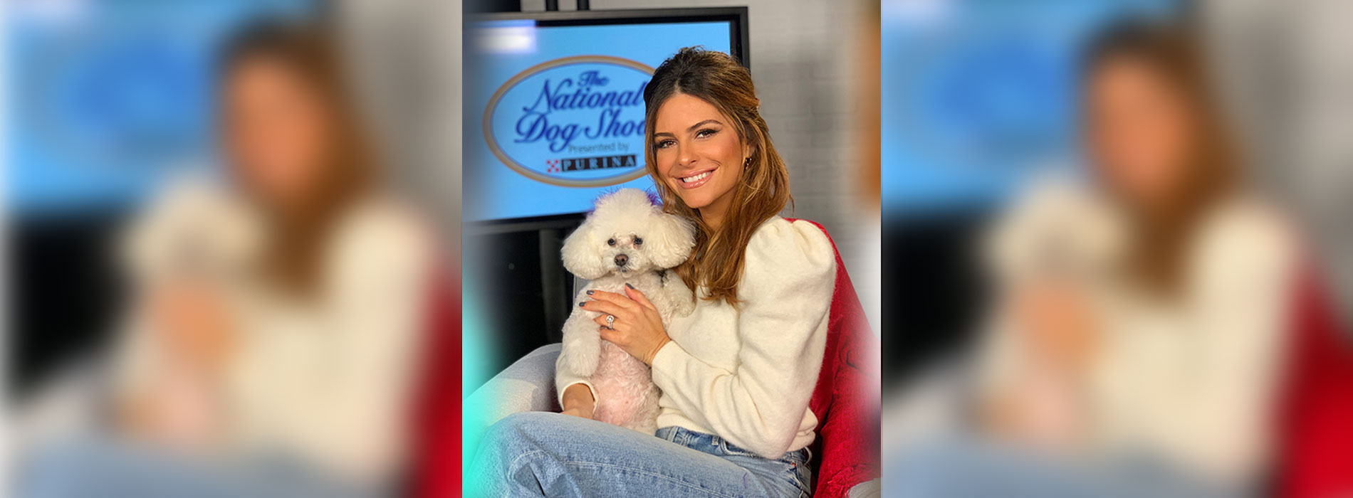 Woman smiling and holding a dog.