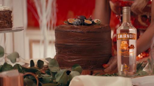 Smirnoff Kissed Caramel is playfully hidden in a fruitcake in Smirnoff’s new holiday campaign.