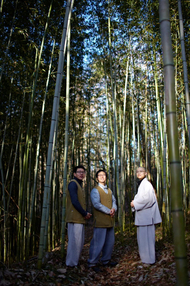 A monk and Templestay participants on a forest path