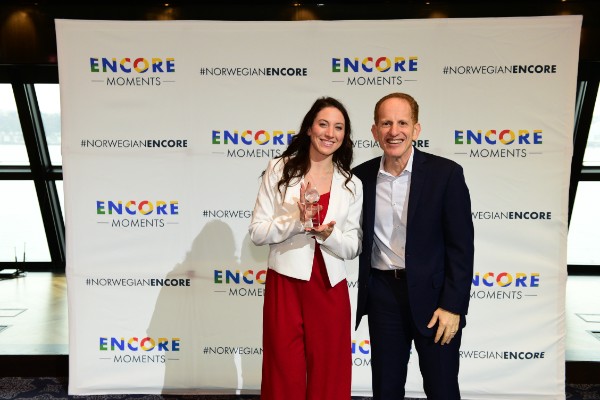 Harry Sommer, incoming president and chief executive officer of Norwegian Cruise Line, presents Leah Egan, Encore Moments winner from Minnesota, with her award at a celebration today in New York City.