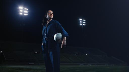 Two-time Olympic gold medalist and two-time FIFA Women's World Cup champion, Carli Lloyd, strikes a powerful stance on the soccer field in her Rosie Reborn jumpsuit.  Photo Credit: Cotton Incorporated