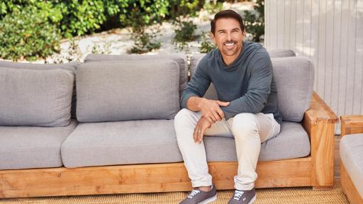 A man sitting on a couch smiling
