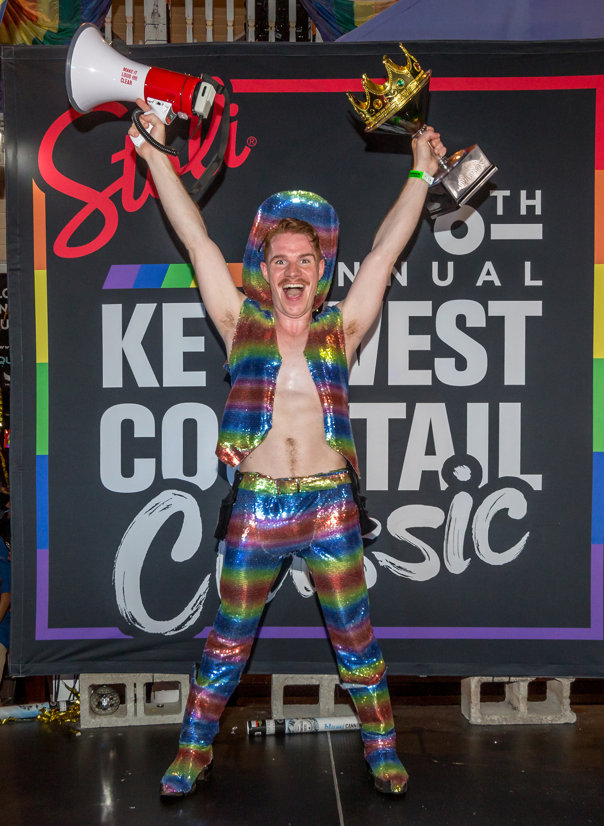 2019 Stoli Key West Cocktail Classic Winner Sam Benedict celebrates with trophy in hand during last year's Key West Pride Week.