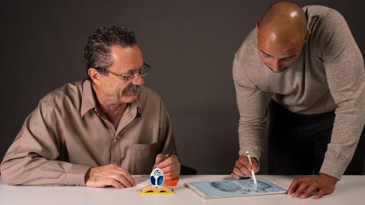 Two men discussing design of the egg