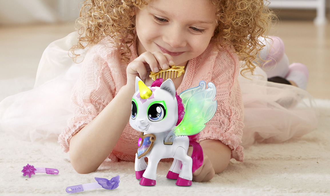 Little girl playing with unicorn