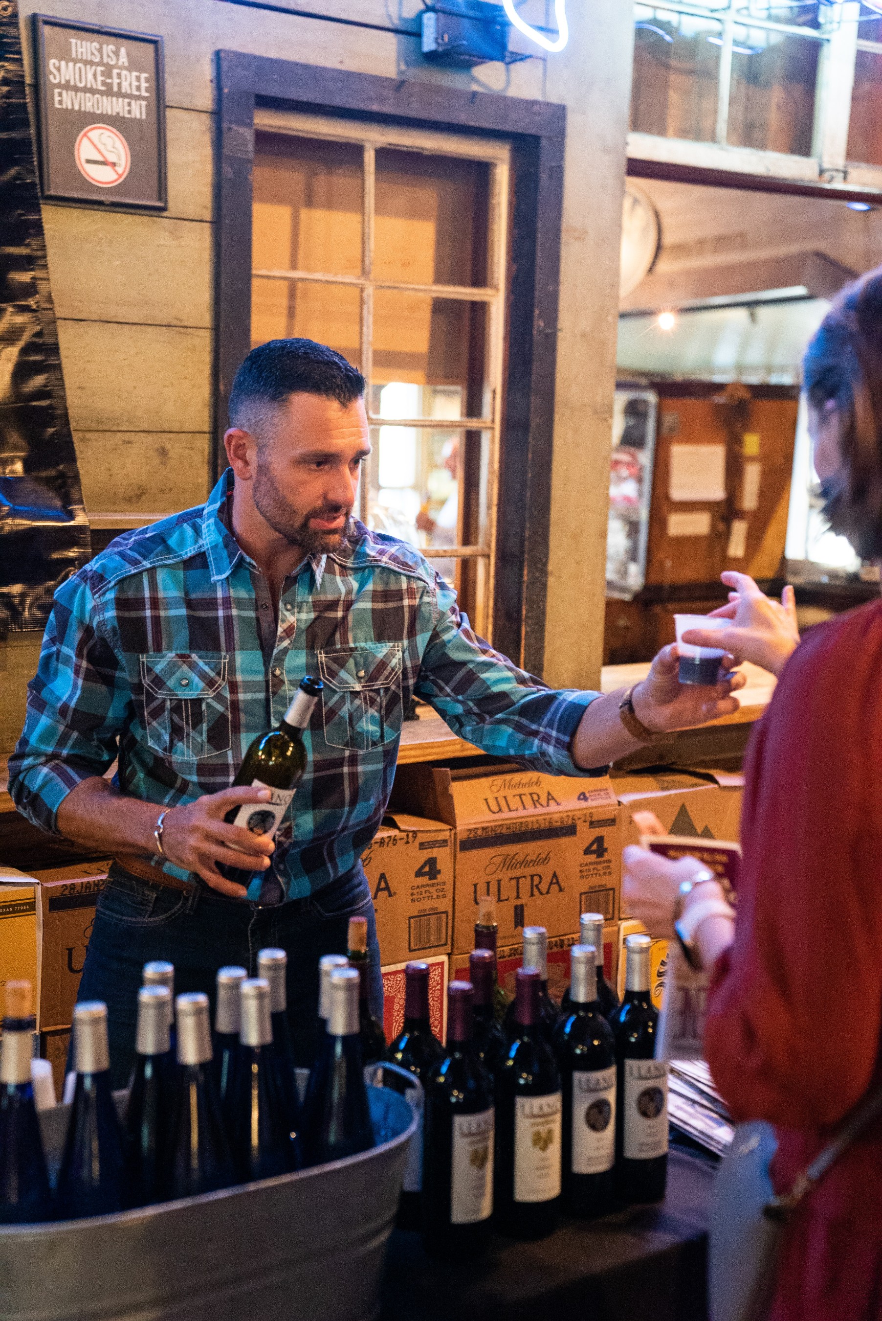 A server pours a glass of Llano Estacado wine at Gruene Hall during the Gruene Wine & Music Festival. The Grapevine in Gruene, which has one of the largest selections of Texas wines, hosts the annual festival each October.