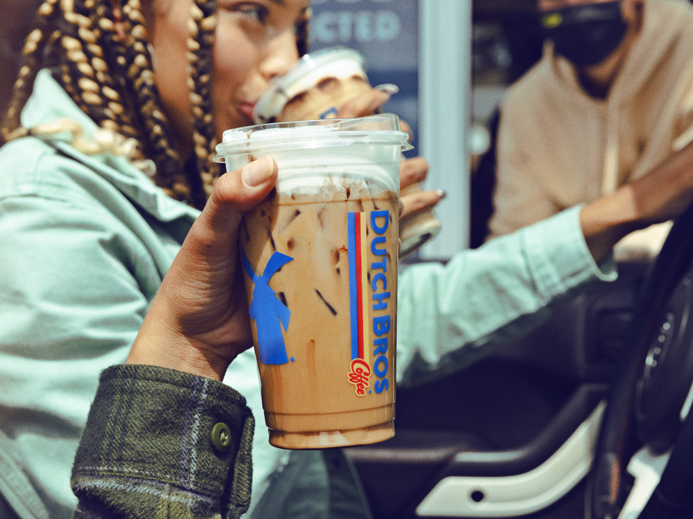 Person holding a large frozen coffee drink