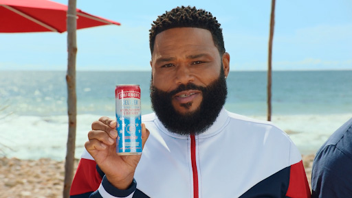 Anthony sipping on his favorite summer drink – Smirnoff Seltzer Red, White & Berry.
