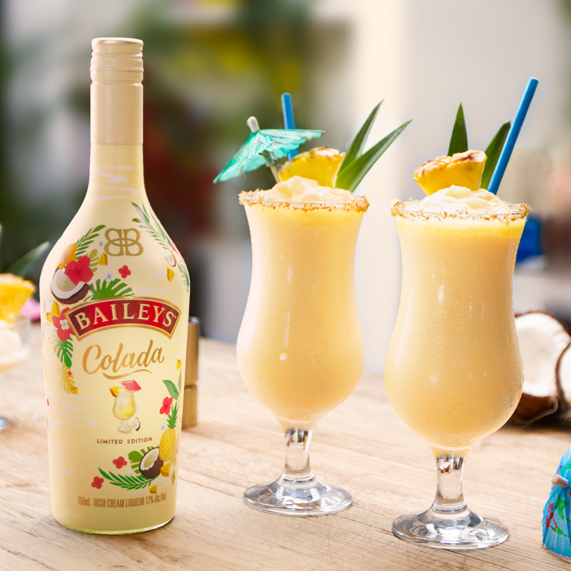 Bottle of Baileys Colada with Pina Colada drinks.
